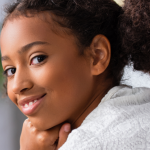 young girl with her hand under her chin